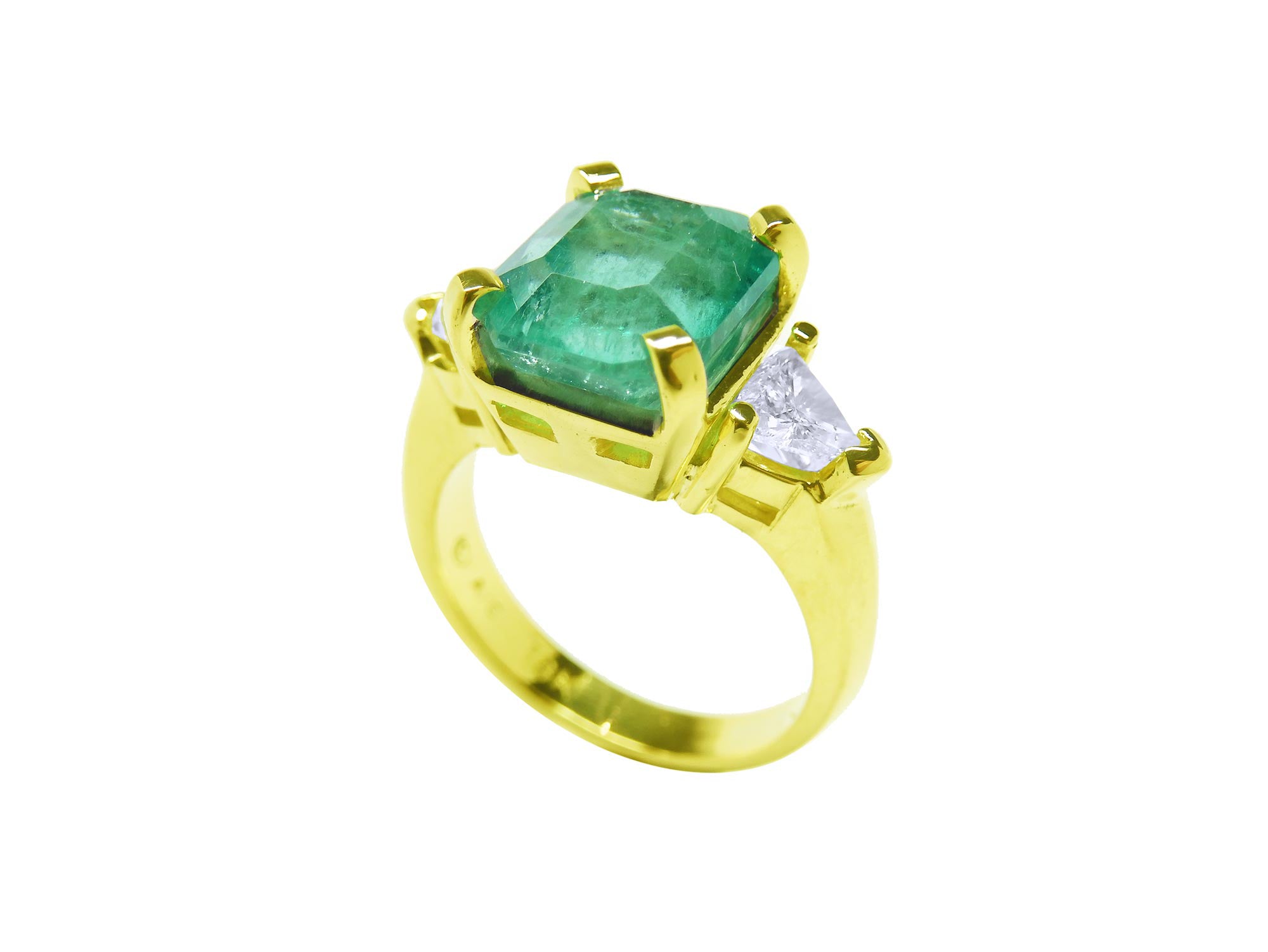 A natural emerald and diamond ring for women on lateral profile view.