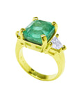 A natural emerald and diamond ring for women on lateral profile view.