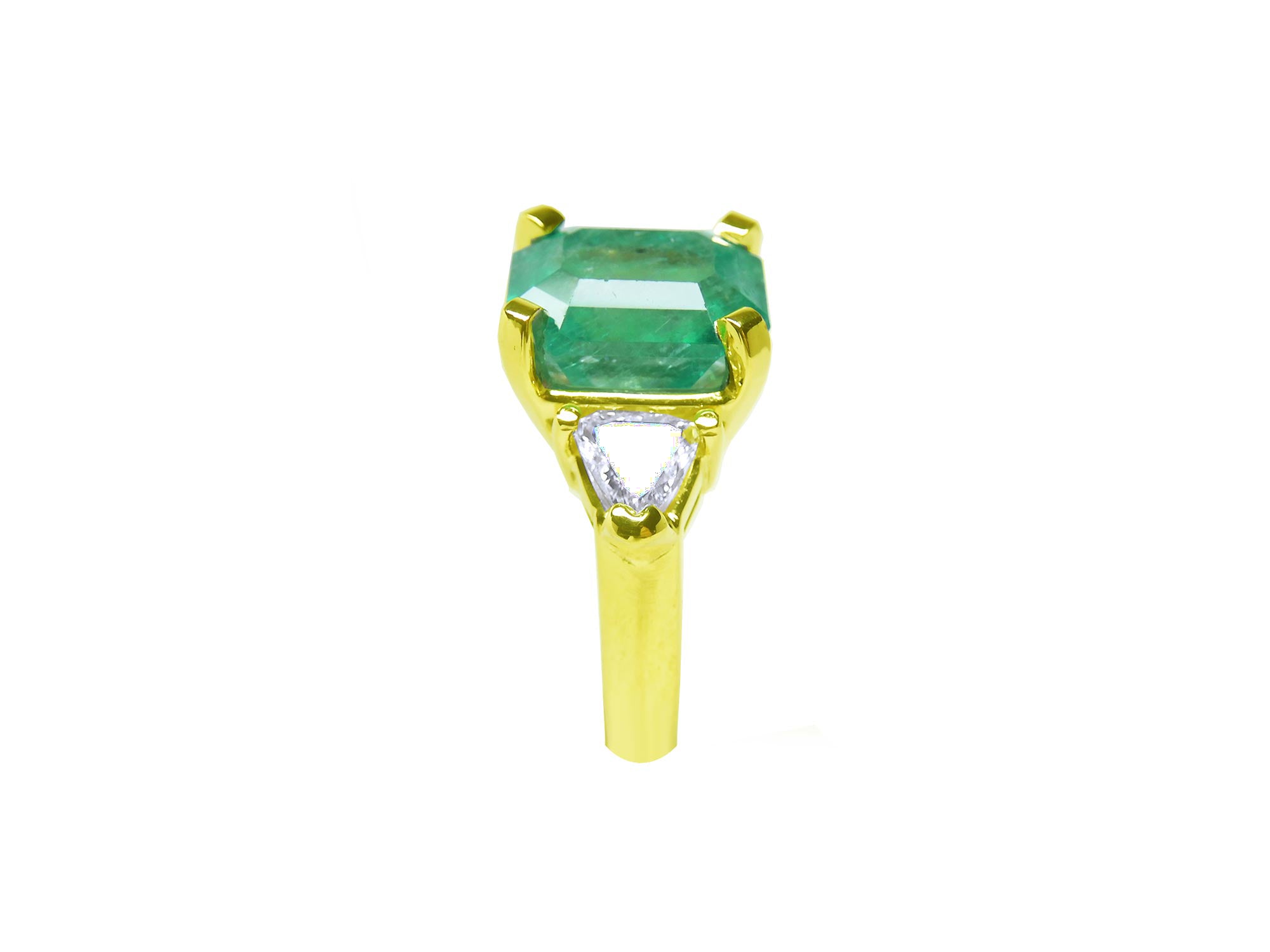 In a tilted position this emerald-cut emerald ring for women displays its side profile.