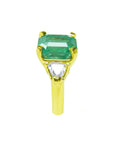 In a tilted position this emerald-cut emerald ring for women displays its side profile.