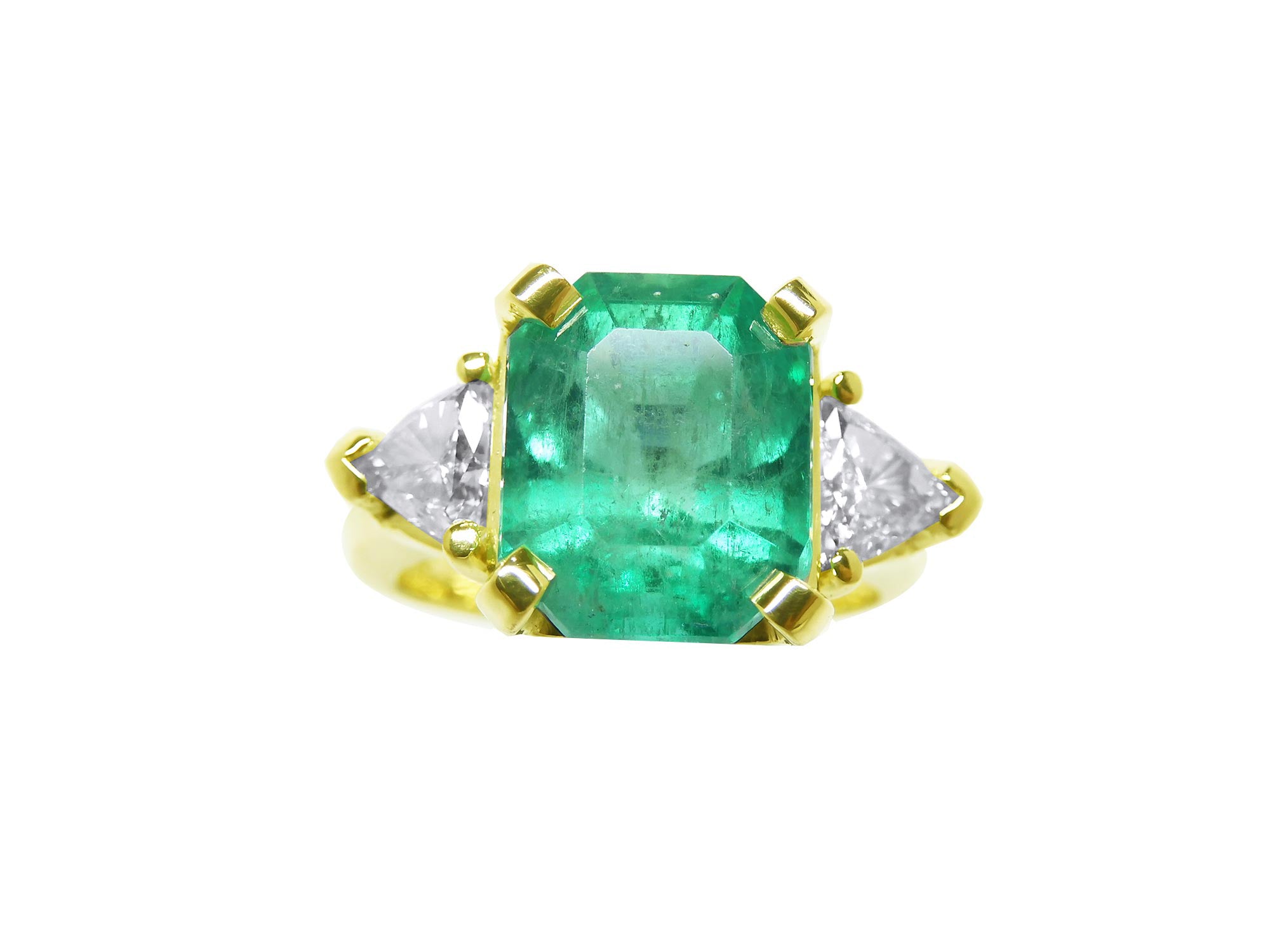 Three stone emerald and trillion cut side diamond ring, front position top view.
