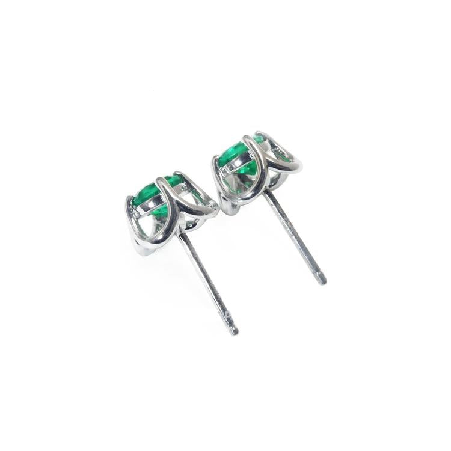 Pair of tulip design emerald stud earrings in 14K white gold with push backs.