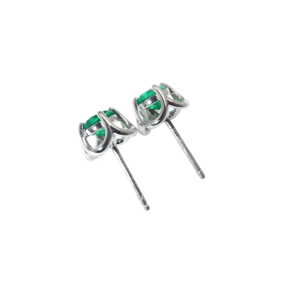 Pair of tulip design emerald stud earrings in 14K white gold with push backs.