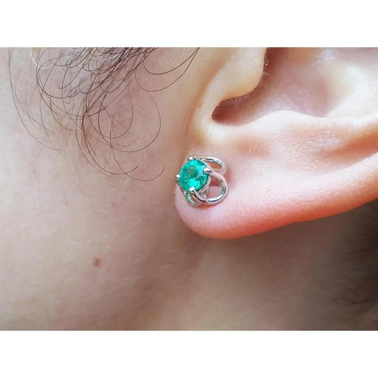 Tulip emerald stud earrings with round cut natural Muzo Colombian emeralds in 14K white gold.