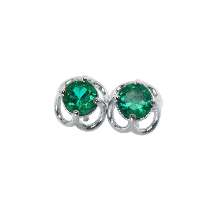 Pair of emerald tulip natural emerald stud earrings made of 14k white gold.