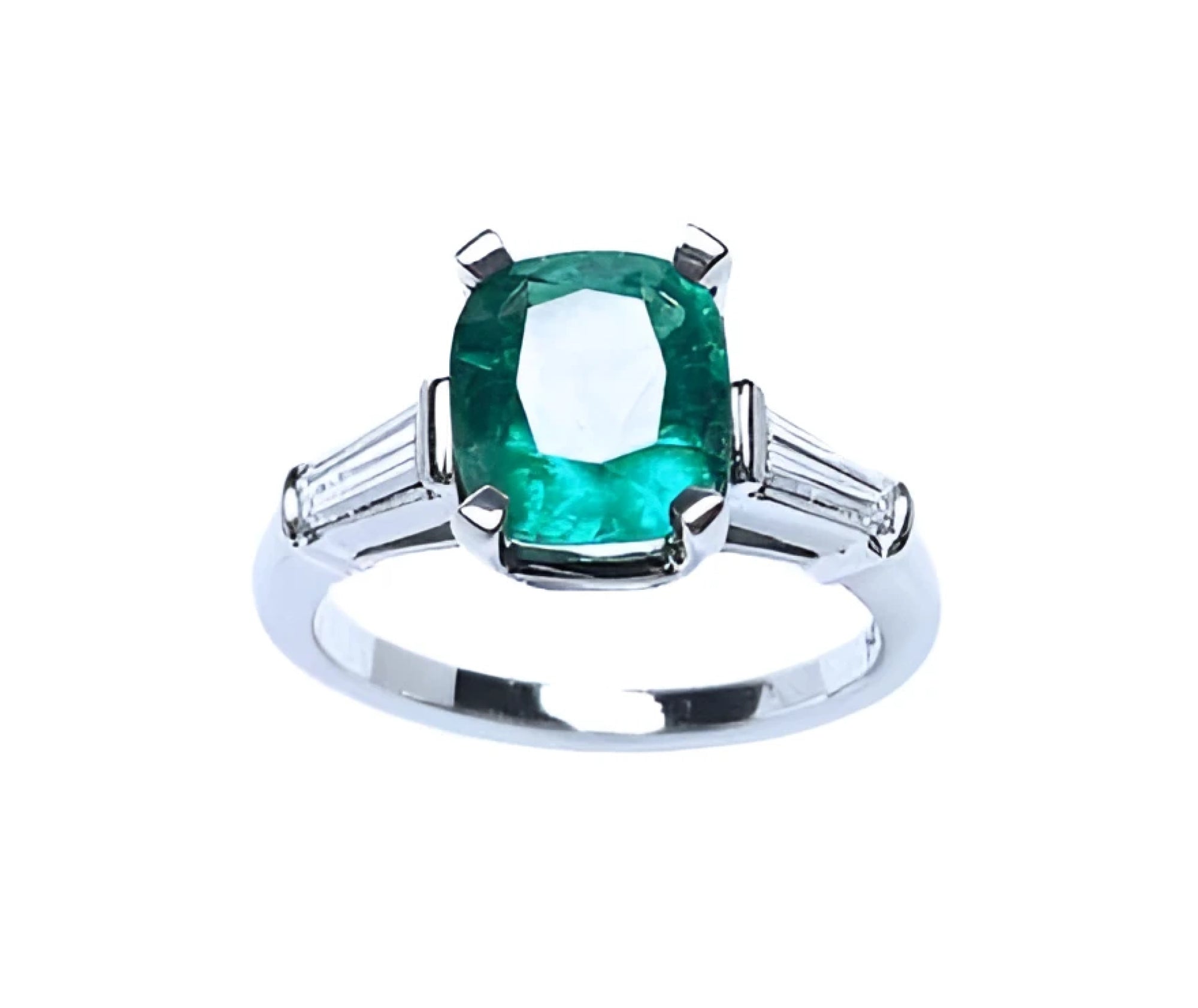 An emerald engagement ring meaning genuine love and reborn. top profile view side diamond tapered baguettes.