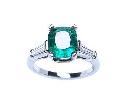 An emerald engagement ring meaning genuine love and reborn. top profile view side diamond tapered baguettes.