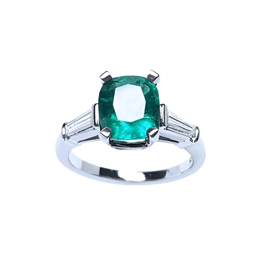 An emerald engagement ring meaning genuine love and reborn. top profile view side diamond tapered baguettes.