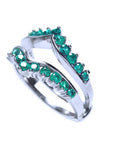 A colombian emerald enhancer ring displaying the side profile.