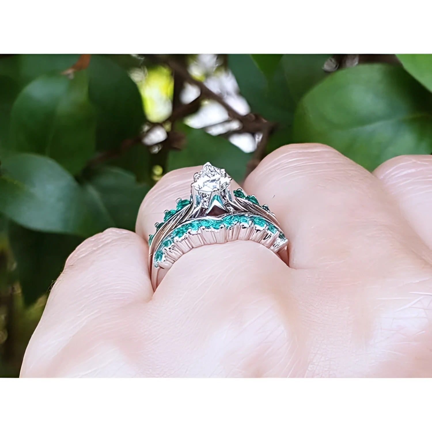 14k white gold emerald ring enhancer with 22 round cut Colombian emeralds, worn with a solitaire ring.