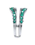 A deep green Colombian emeralds enhancer ring displaying its side profile