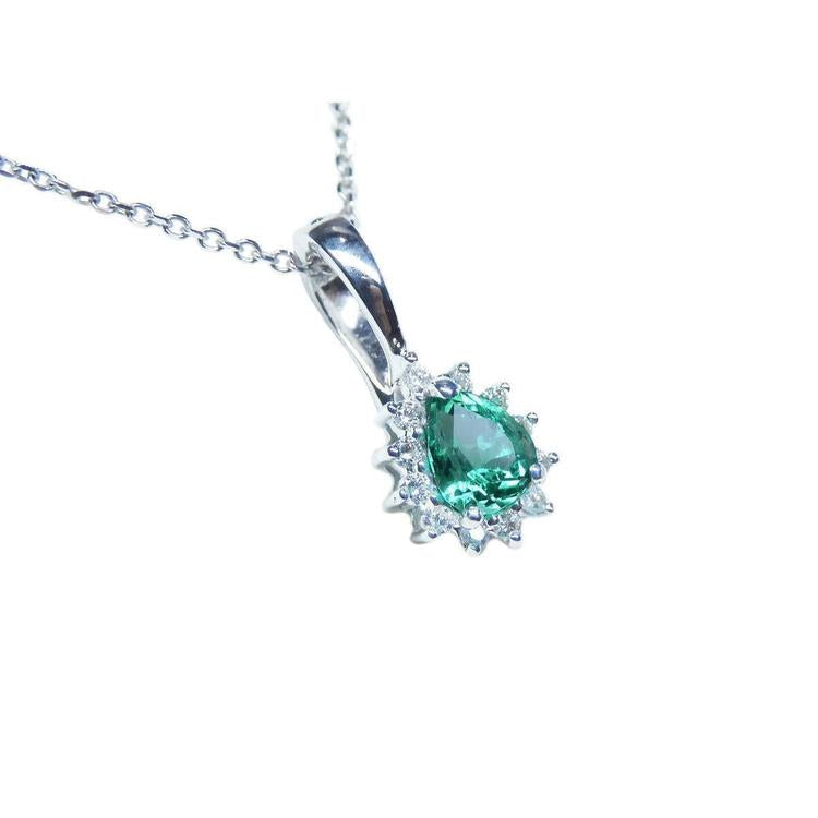 White gold enhancer pendant with a natural emerald gemstone on a right topside position.