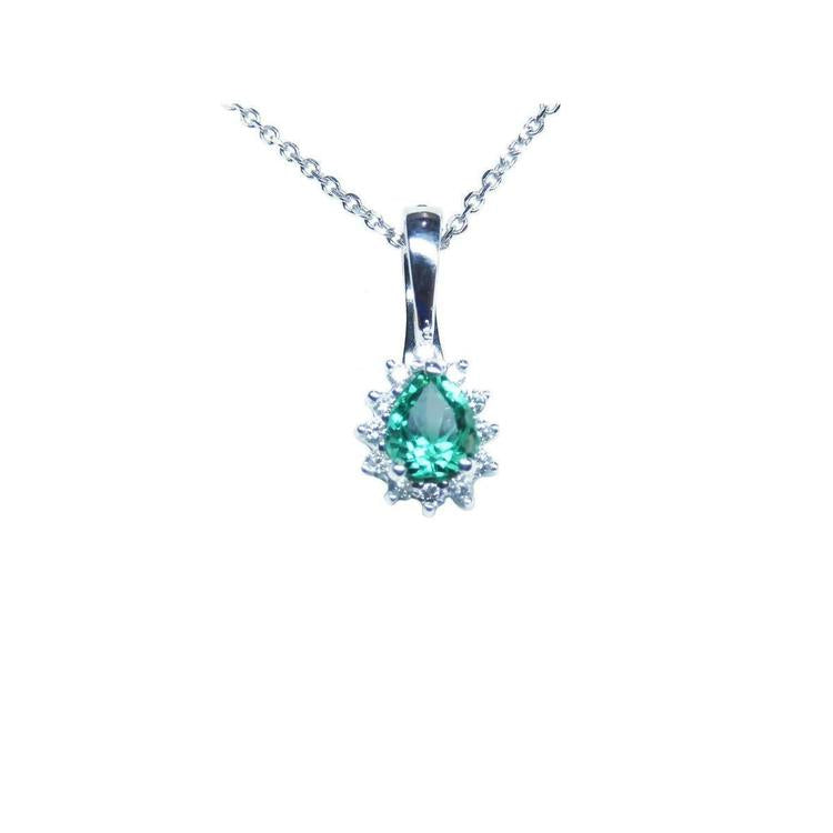 A pear shaped emerald enhancer pendant necklace displaying its topside view.