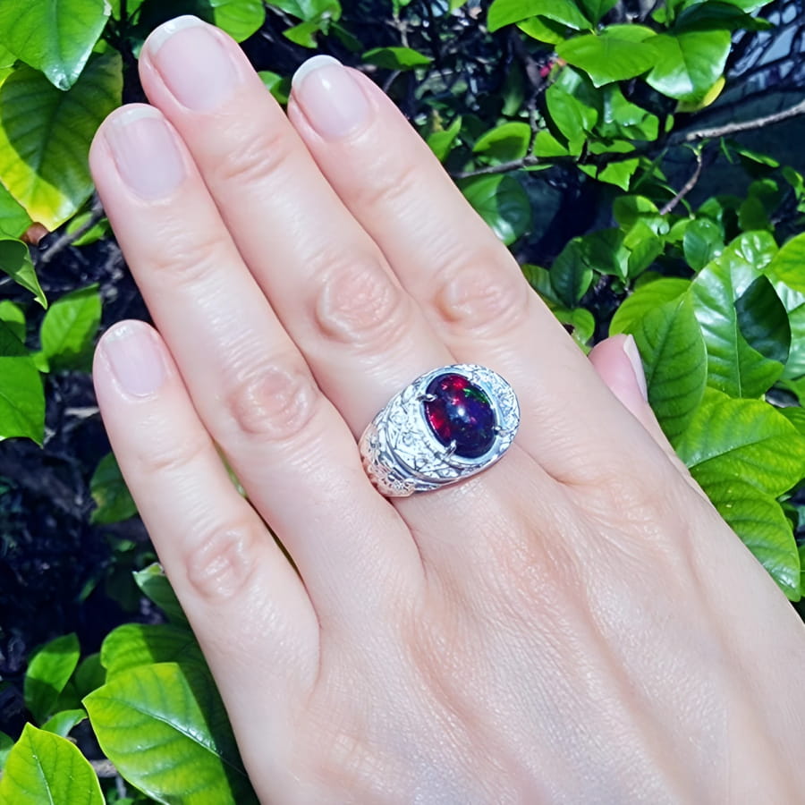 Men's sterling silver ring with a fiery red, green, and blue Ethiopian black opal.