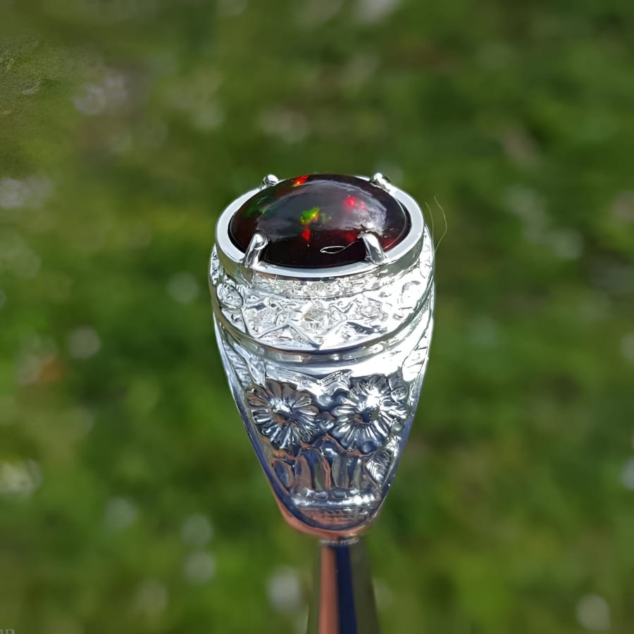Men's sterling silver ring with a fiery red, green, and blue Ethiopian black opal.