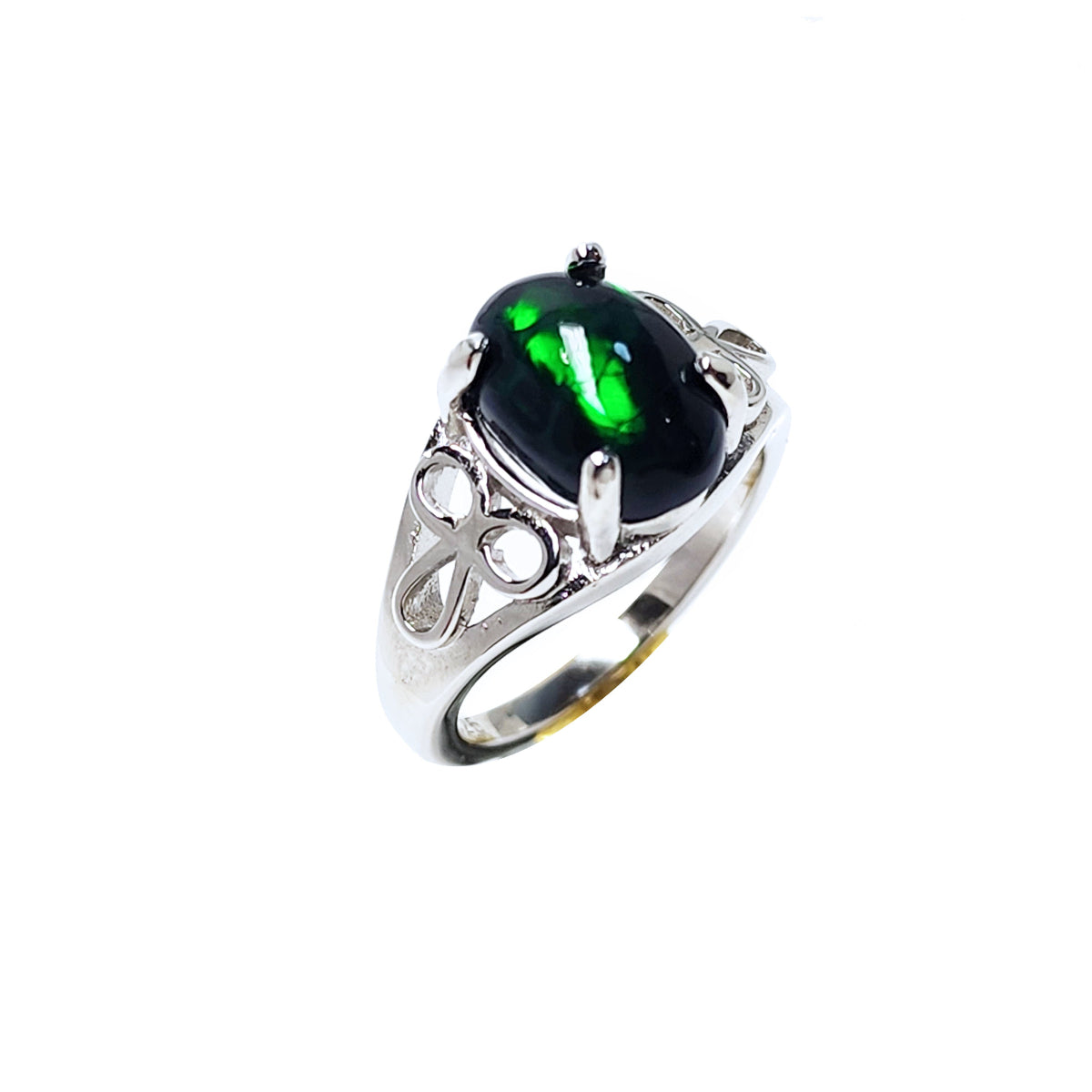 Silver ring with a natural black opal on a tilted position, topside and lateral side profile view.