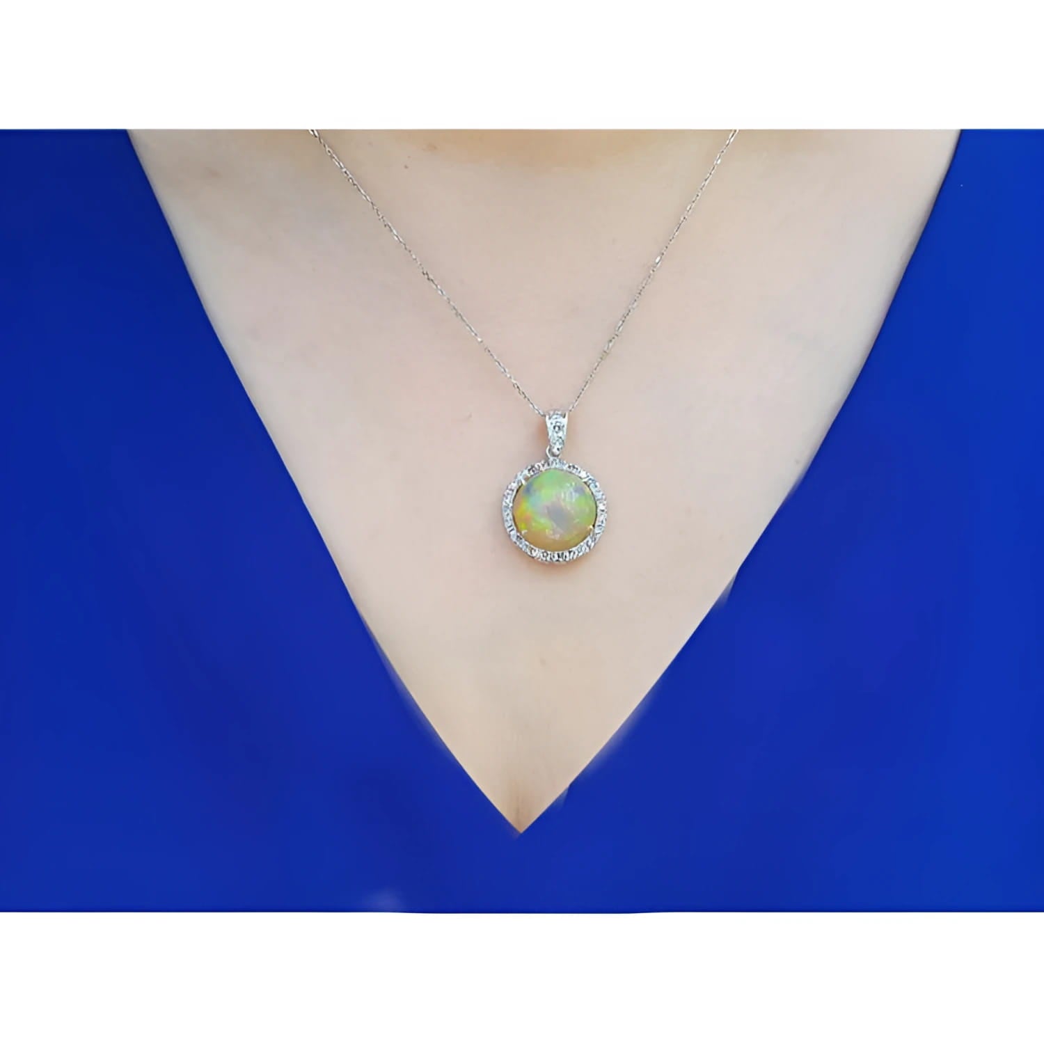 Ethiopian Welo opal and diamond pendant in 14K white gold, worn on a woman's neck.