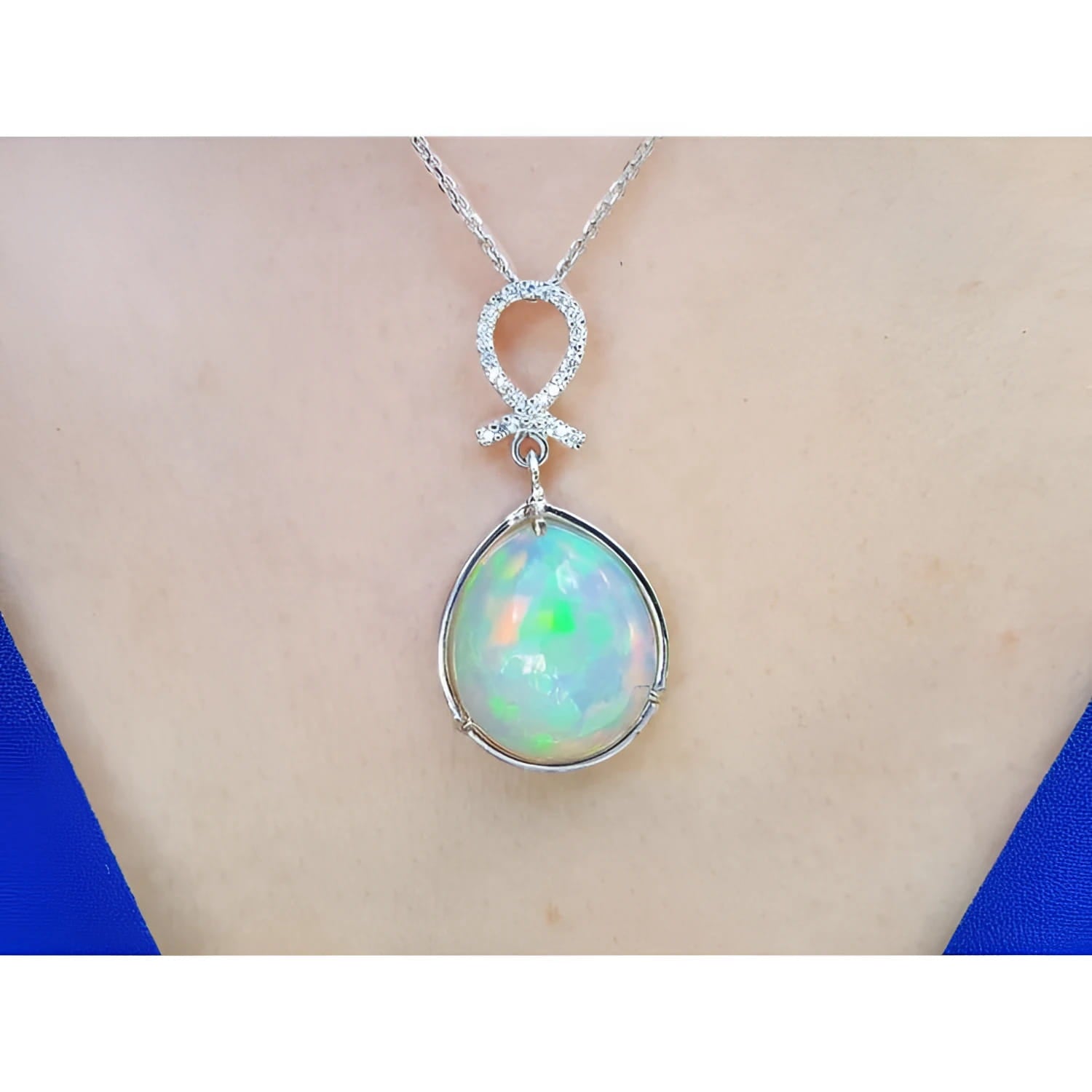 Ethiopian Welo opal and diamond pendant in 14K white gold, worn on a neck.
