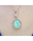 Ethiopian Welo opal and diamond pendant in 14K white gold, worn on a neck.