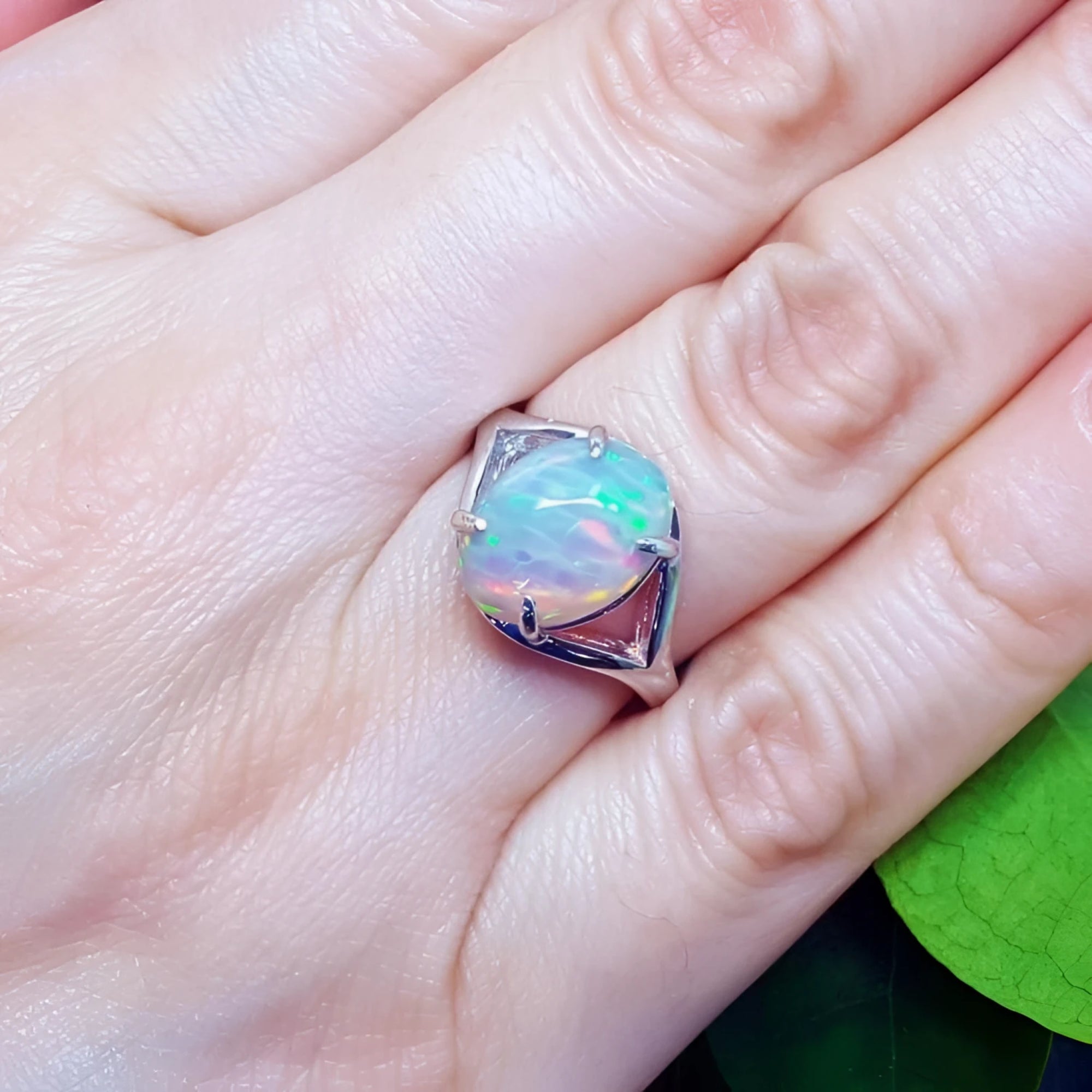 Ethiopian opal sterling silver ring for women with oval cut, red and orange play of color.