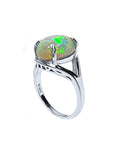 Silver ring with a multicolor opal stone on a white background