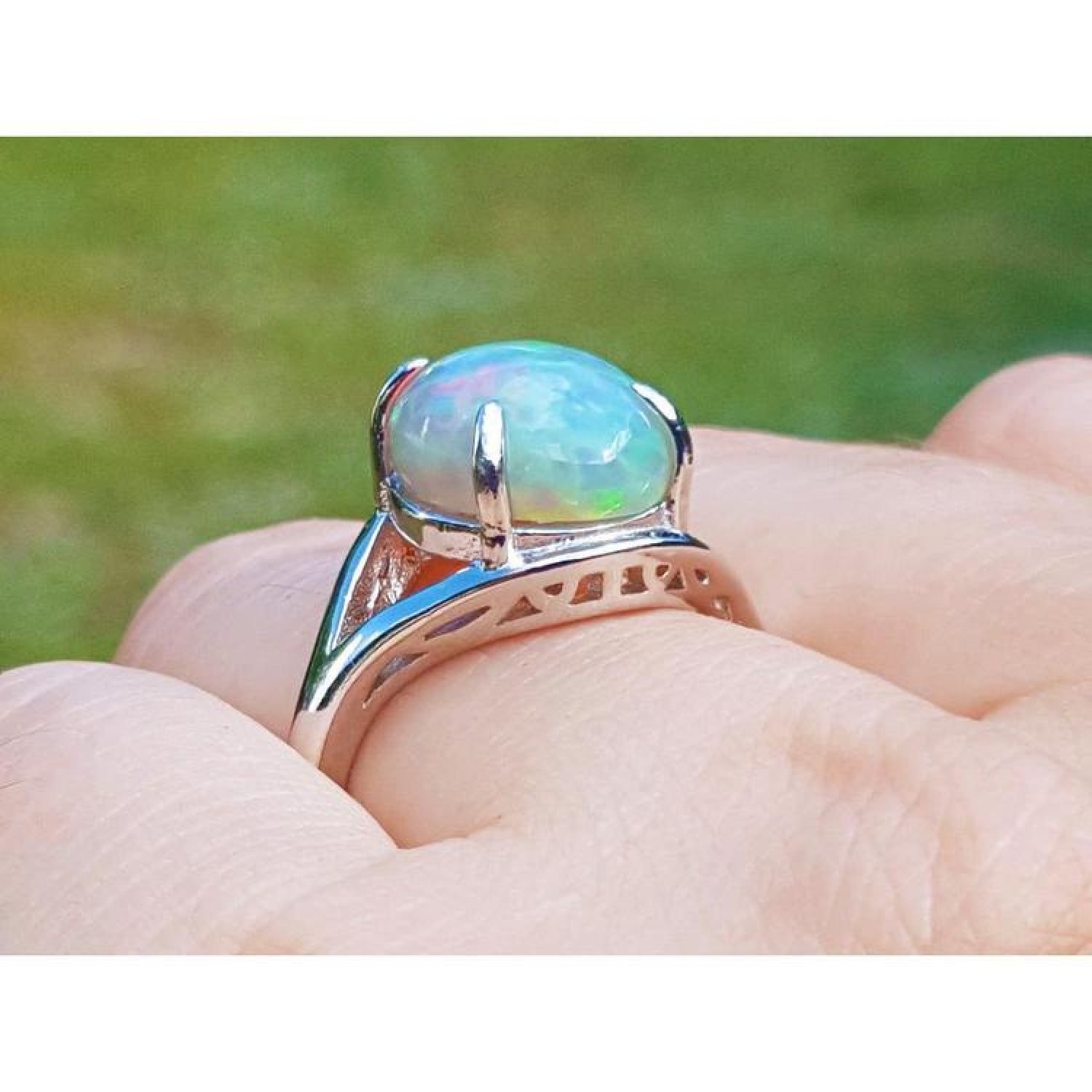 Ethiopian opal silver ring for women, oval cut, showing red and orange play of colors.