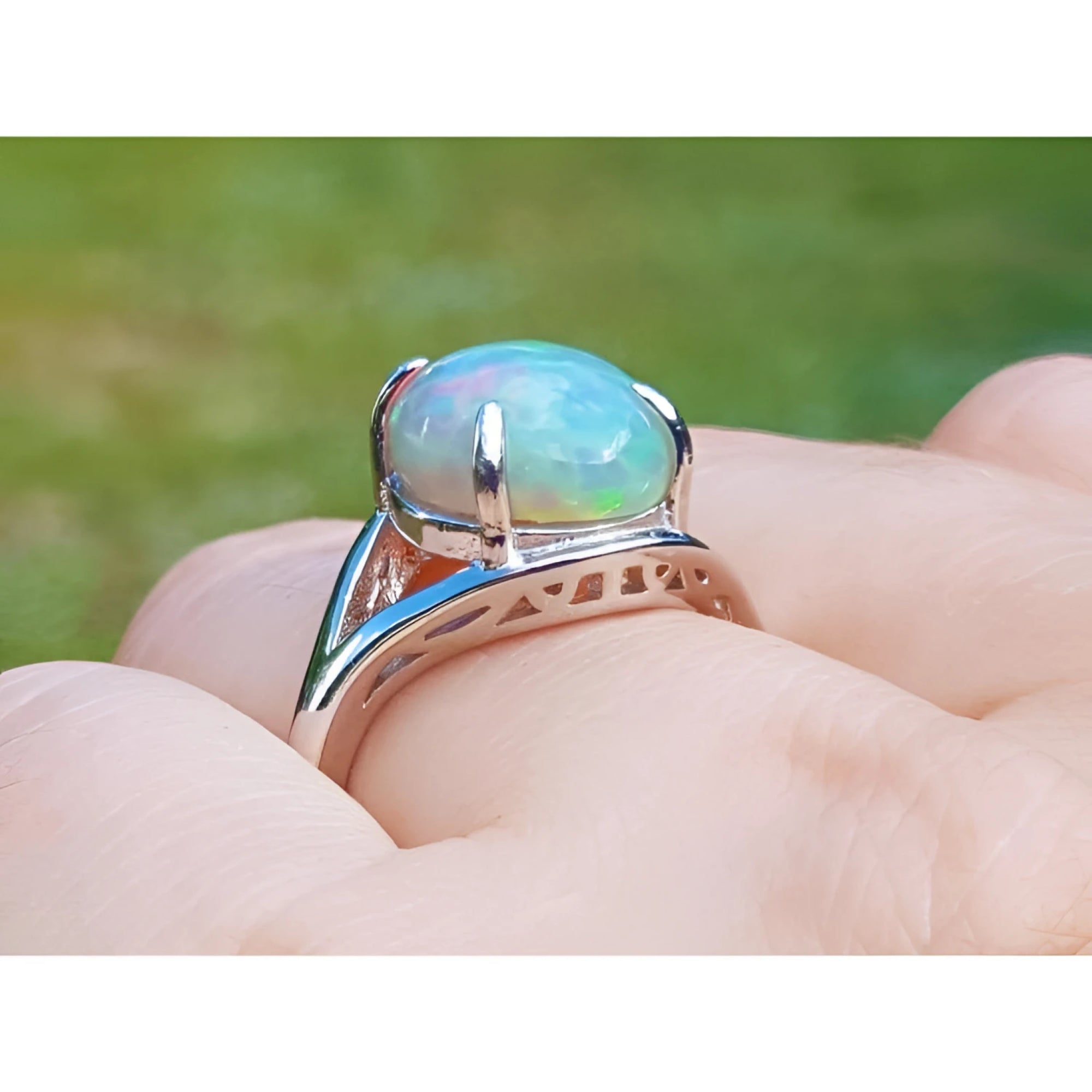 Ethiopian opal silver ring for women, oval cut, showing red and orange play of colors.