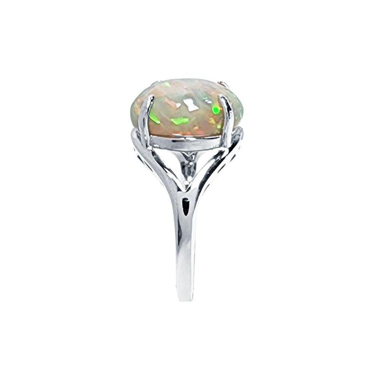 Ethiopian opal sterling silver ring for women with an oval cut, showing red, orange, and green play of color.