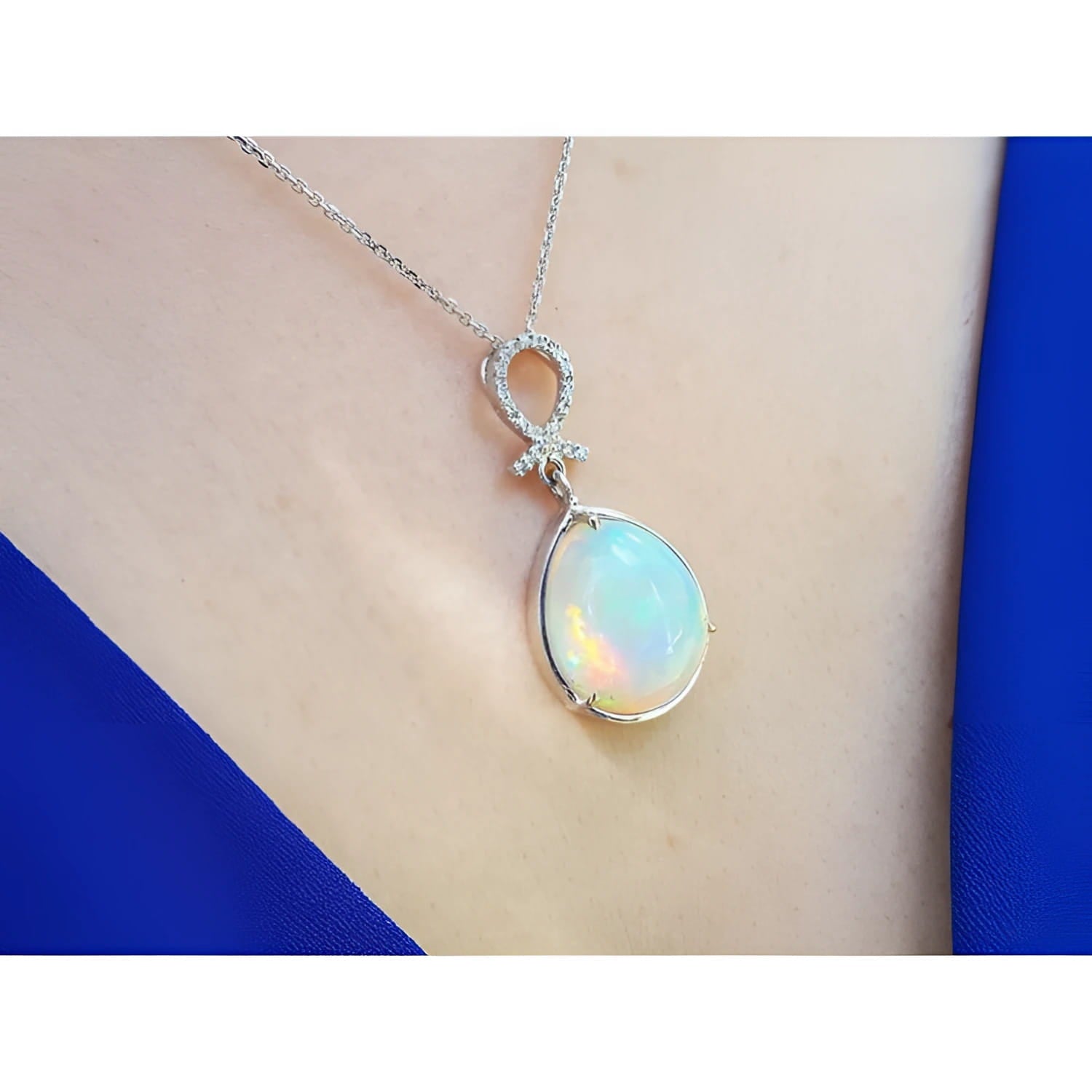 Ethiopian Welo opal and diamond pendant in 14K white gold on a woman's neck.