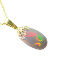 A yellow gold necklace with multicolor Welo Ethiopian opal pendant 