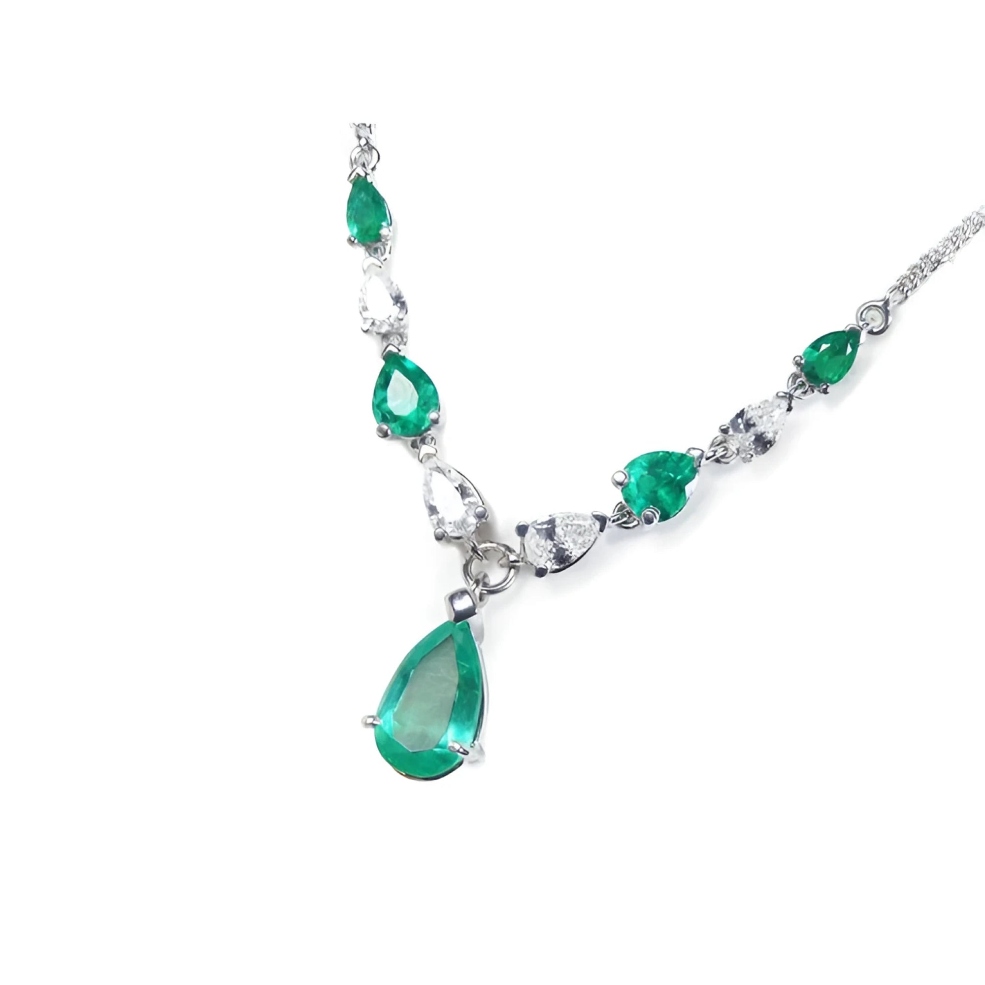 14k white gold necklace with pear-shaped emeralds and diamonds.