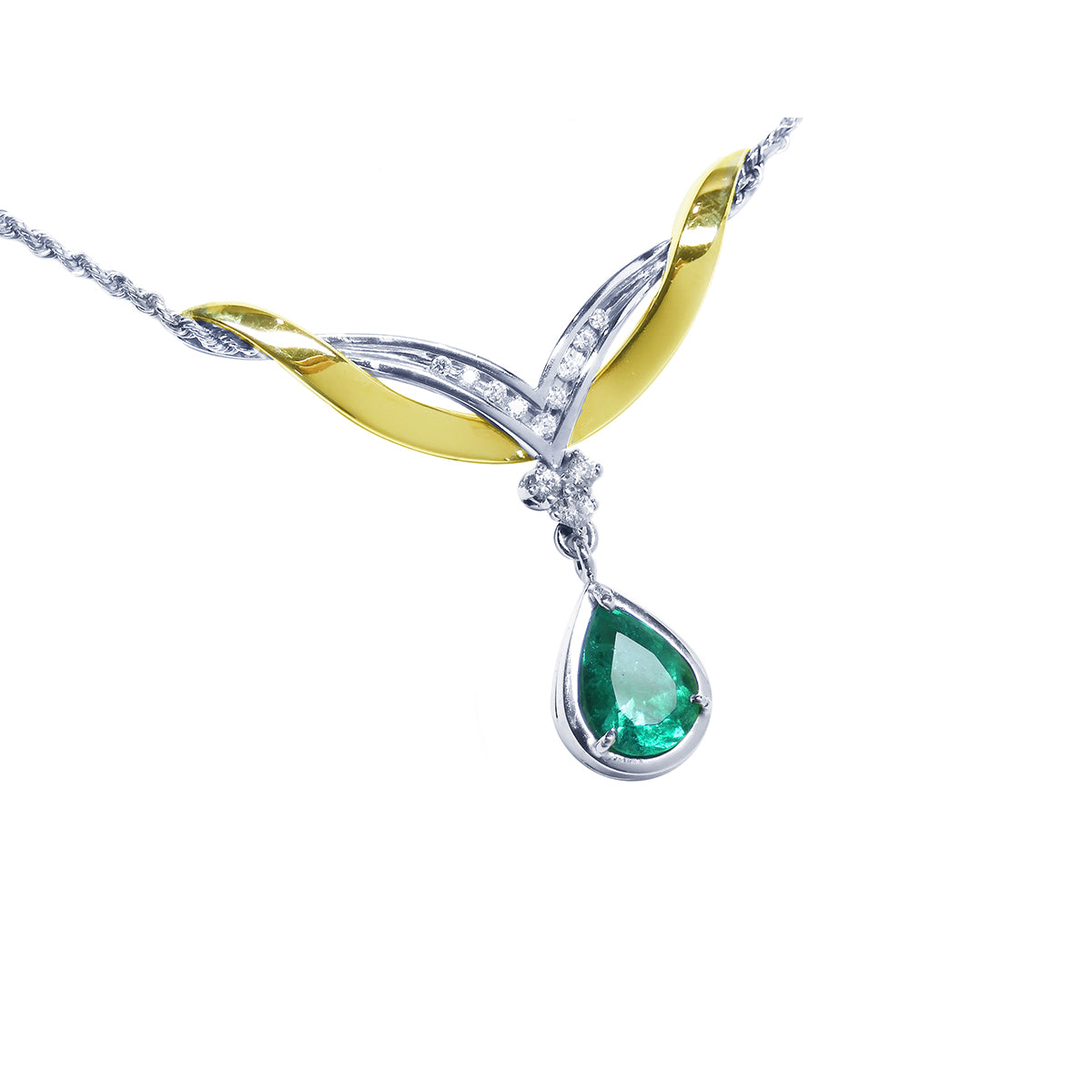 A far view of a white and yellow gold pendant necklace with a natural teardrop emerald dangling on a white background