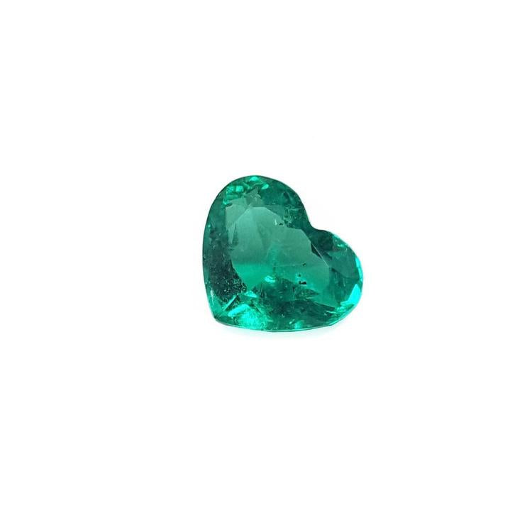 Heart cut loose natural colombian emerald front left side exposing table and crown