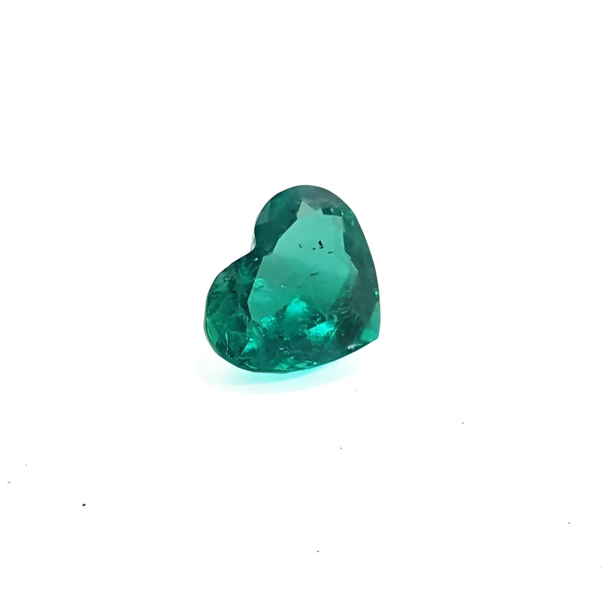 1.14 carat heart cut Colombian emerald with a rich bluish-green color on a white background.