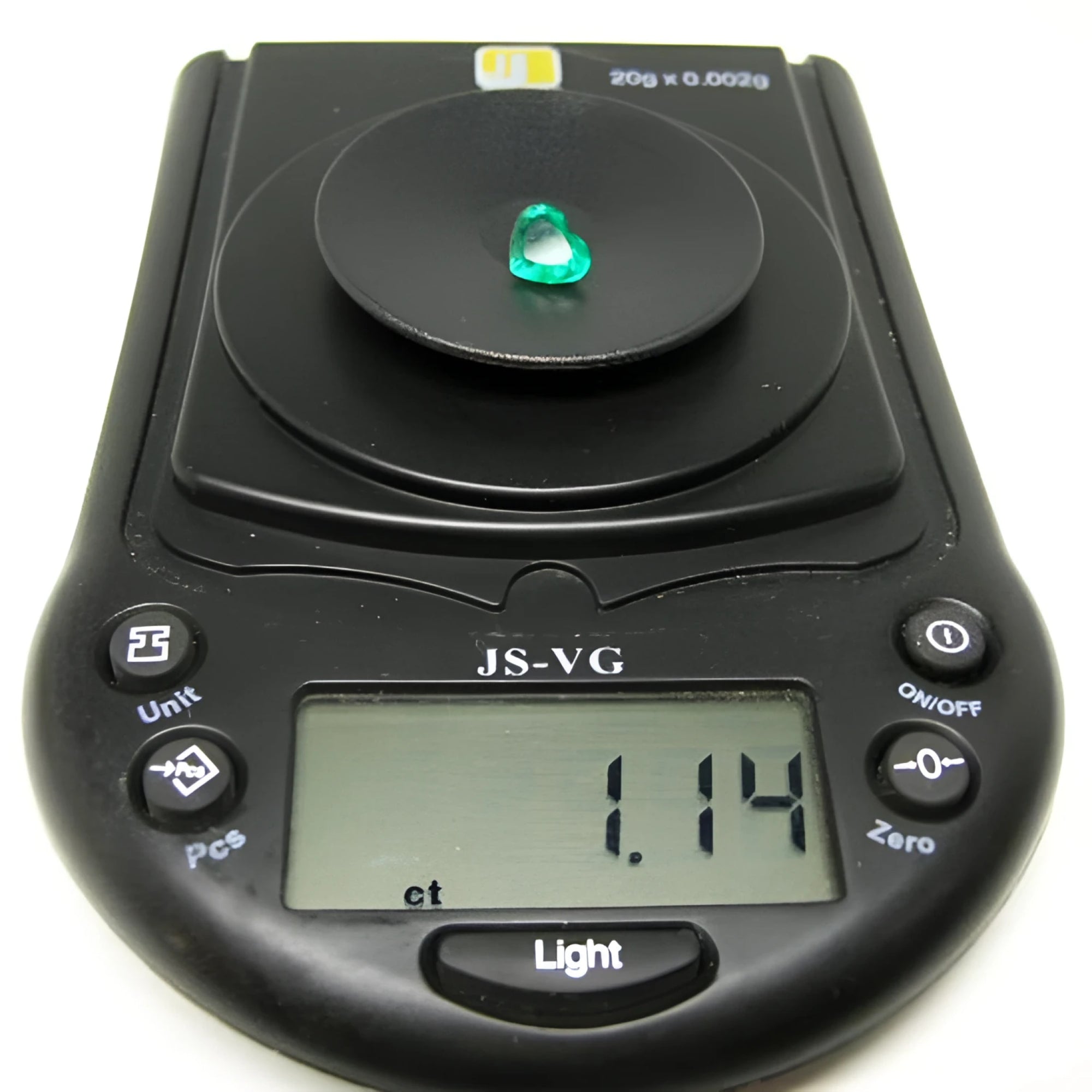 1.14 carat heart-cut Colombian emerald on a black digital jewelry scale.