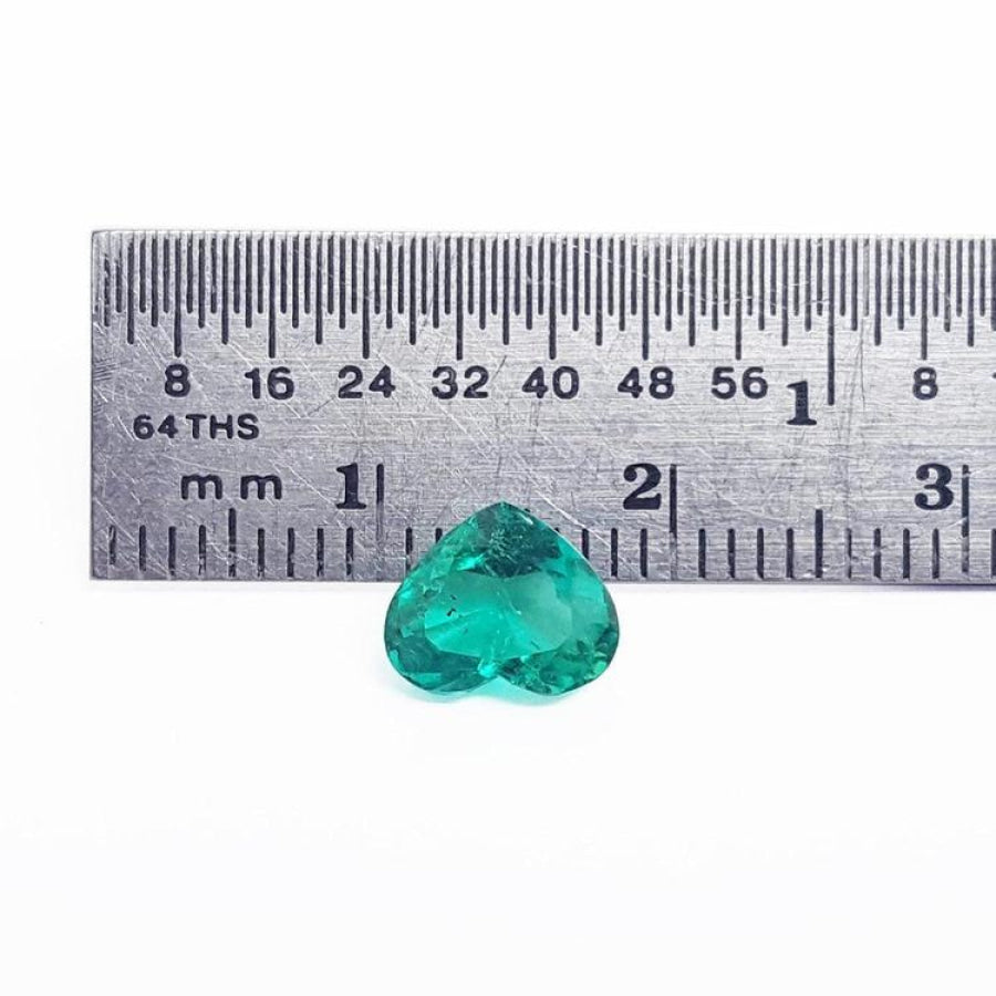 1.14 carat heart-cut Colombian emerald, rich bluish-green, shown with a ruler for scale.