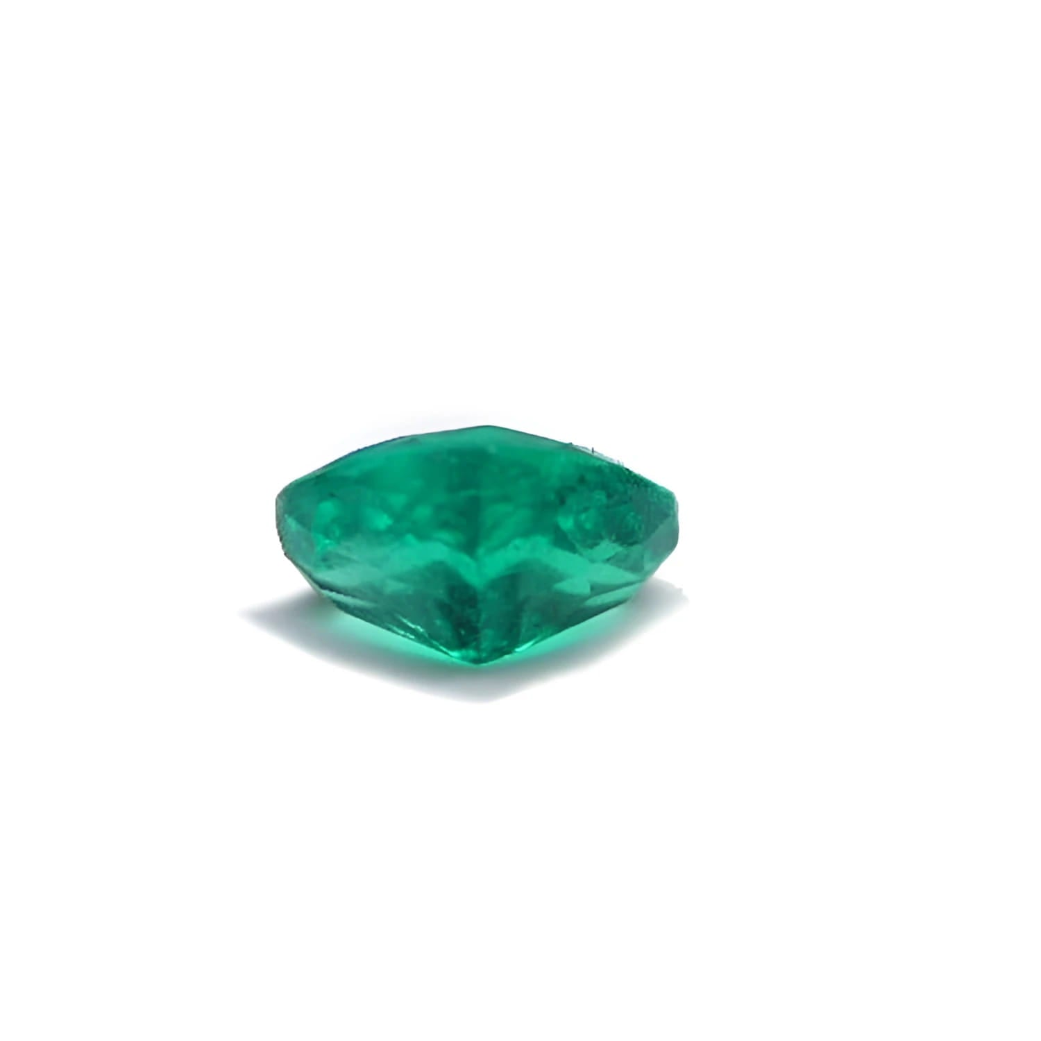 1.14 carat heart cut Colombian emerald with a rich bluish-green color on a white background.