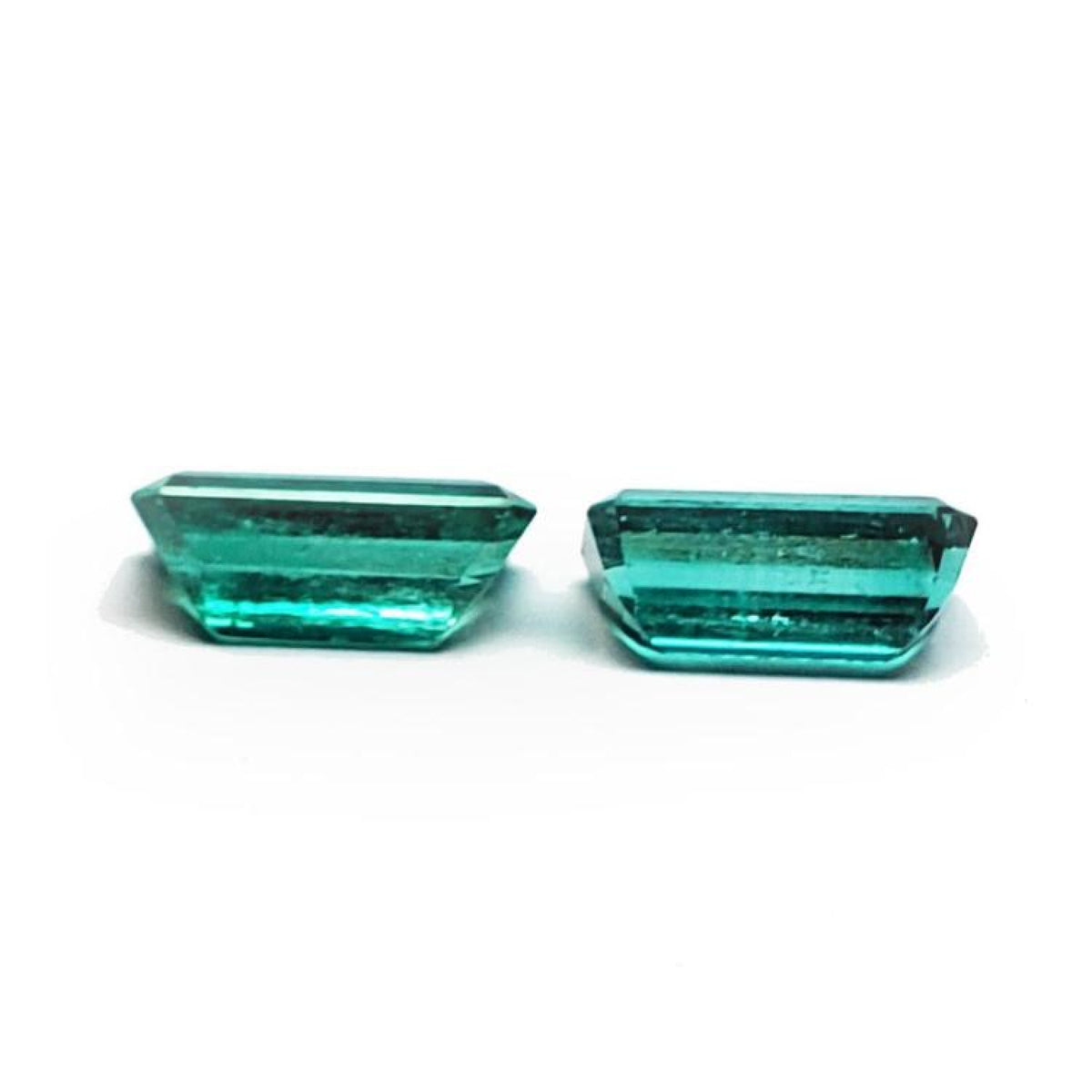 Two sparkling, emerald-cut natural emeralds in a medium deep bluish-green hue, perfect for earrings.