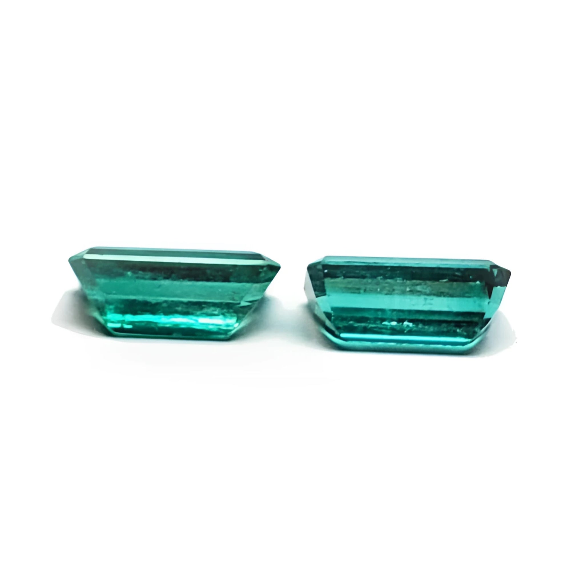 Two sparkling, emerald-cut natural emeralds in a medium deep bluish-green hue, perfect for earrings.