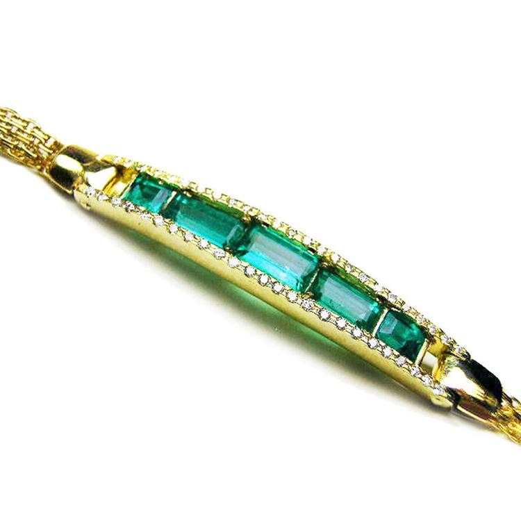 18k gold bracelet with five high qualities natural colombian emeralds and side accent diamonds.