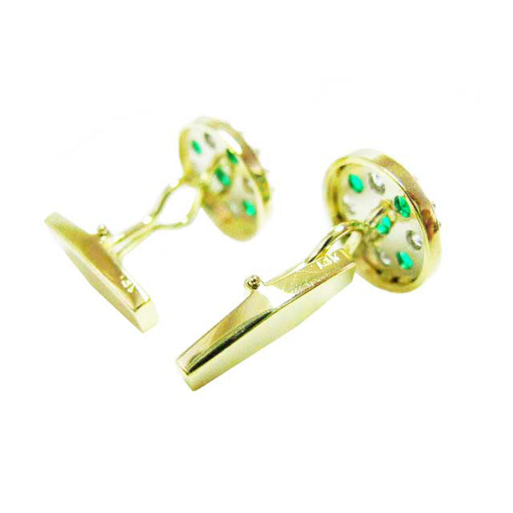 Gold cufflinks with colombian emeralds, downside profile view on a white background