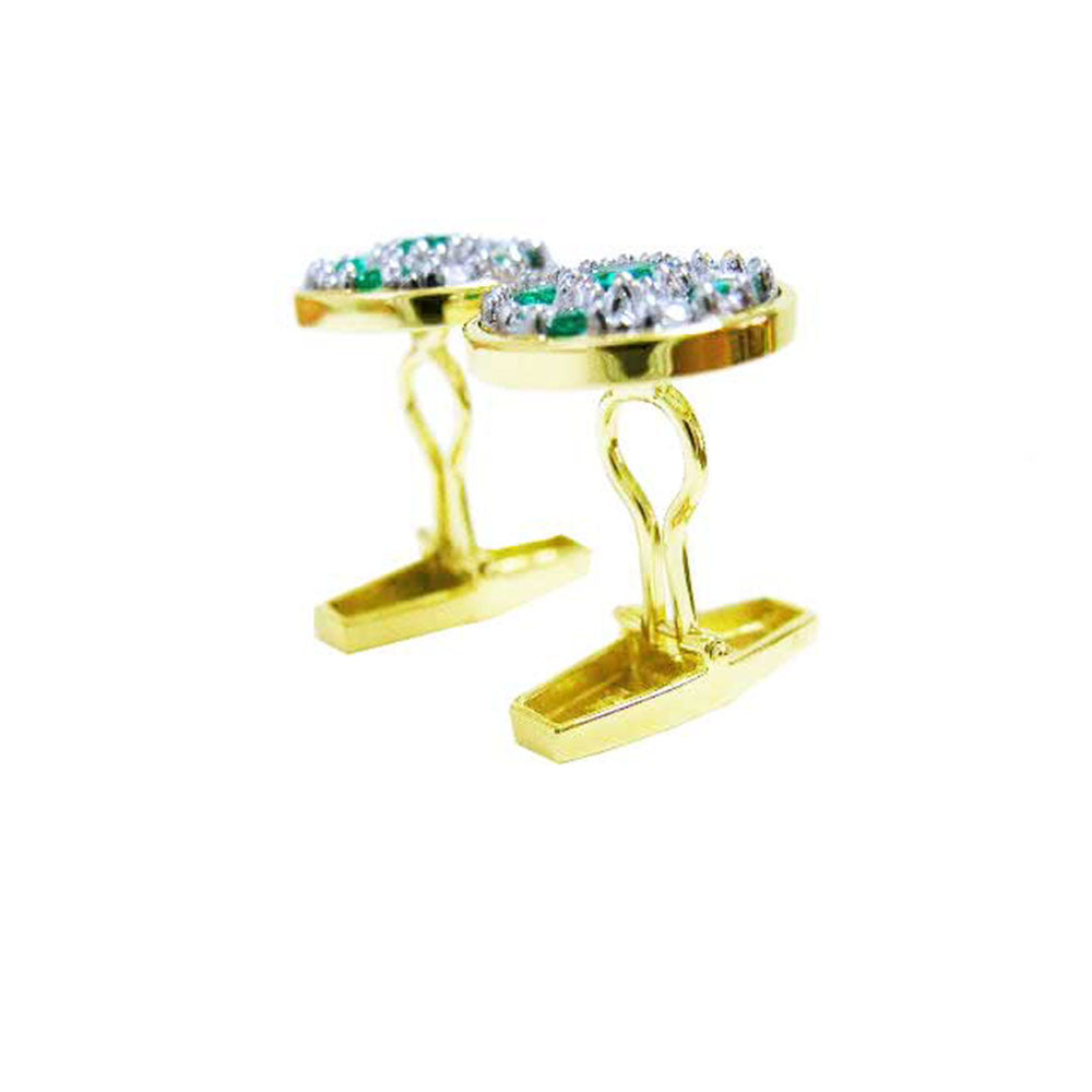 Gold cufflinks with genuine emerald and diamonds on a white background.