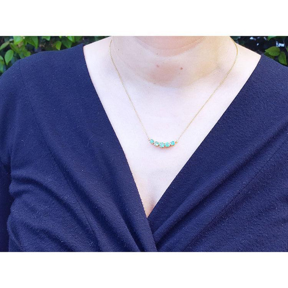 Green Fire Emerald Necklace with five sparkling round cut emeralds on a 14K gold chain.
