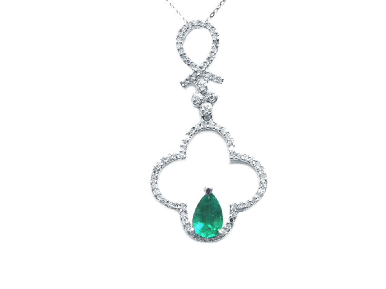 A four-leaf diamond pendant necklace with a central teardrop natural colombian emerald stone.