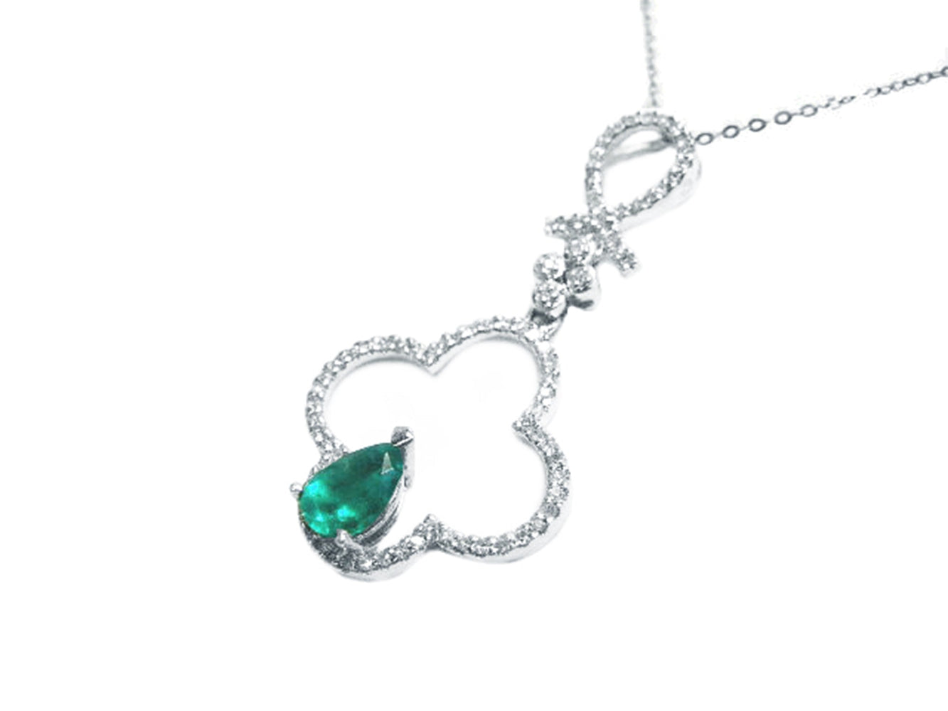 A four-leaf clover emerald pendant crafted in white fold with diamonds.