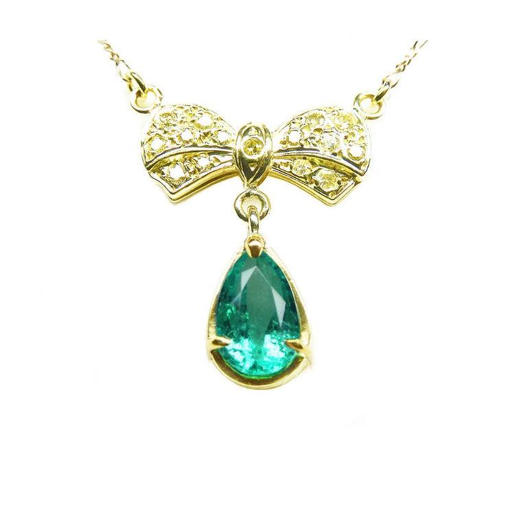 Pear shaped natural emerald bowtie necklace from Muzo mine in Colombia, yellow diamonds pave set in 18k yellow gold