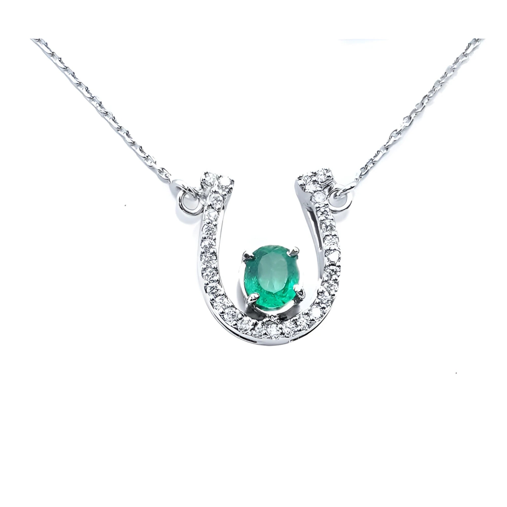 14K white gold horseshoe necklace with a central oval emerald and diamond accents.