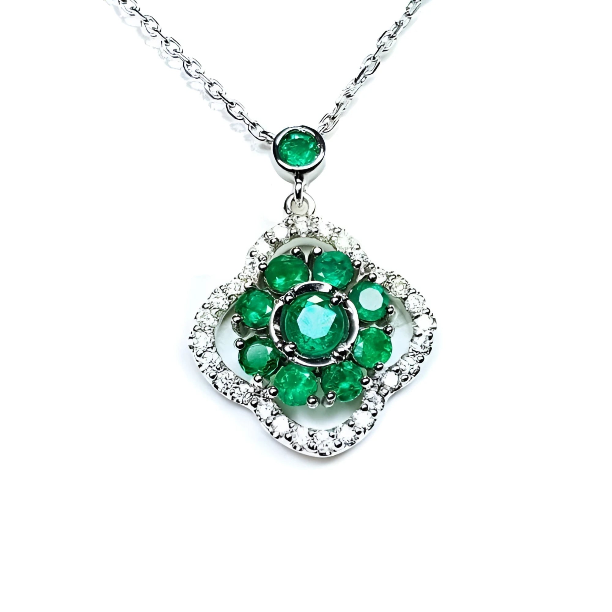 14K white gold cluster necklace with natural Colombian emeralds and diamond clover silhouette.