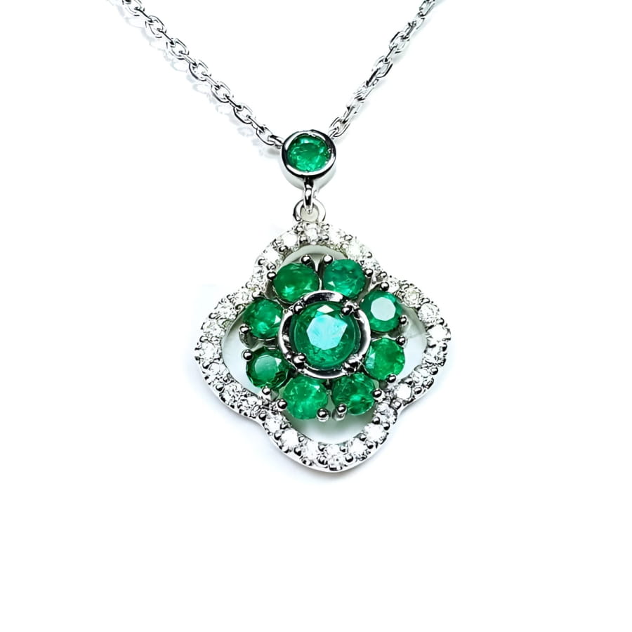 14K white gold cluster necklace with natural Colombian emeralds and diamond clover silhouette.