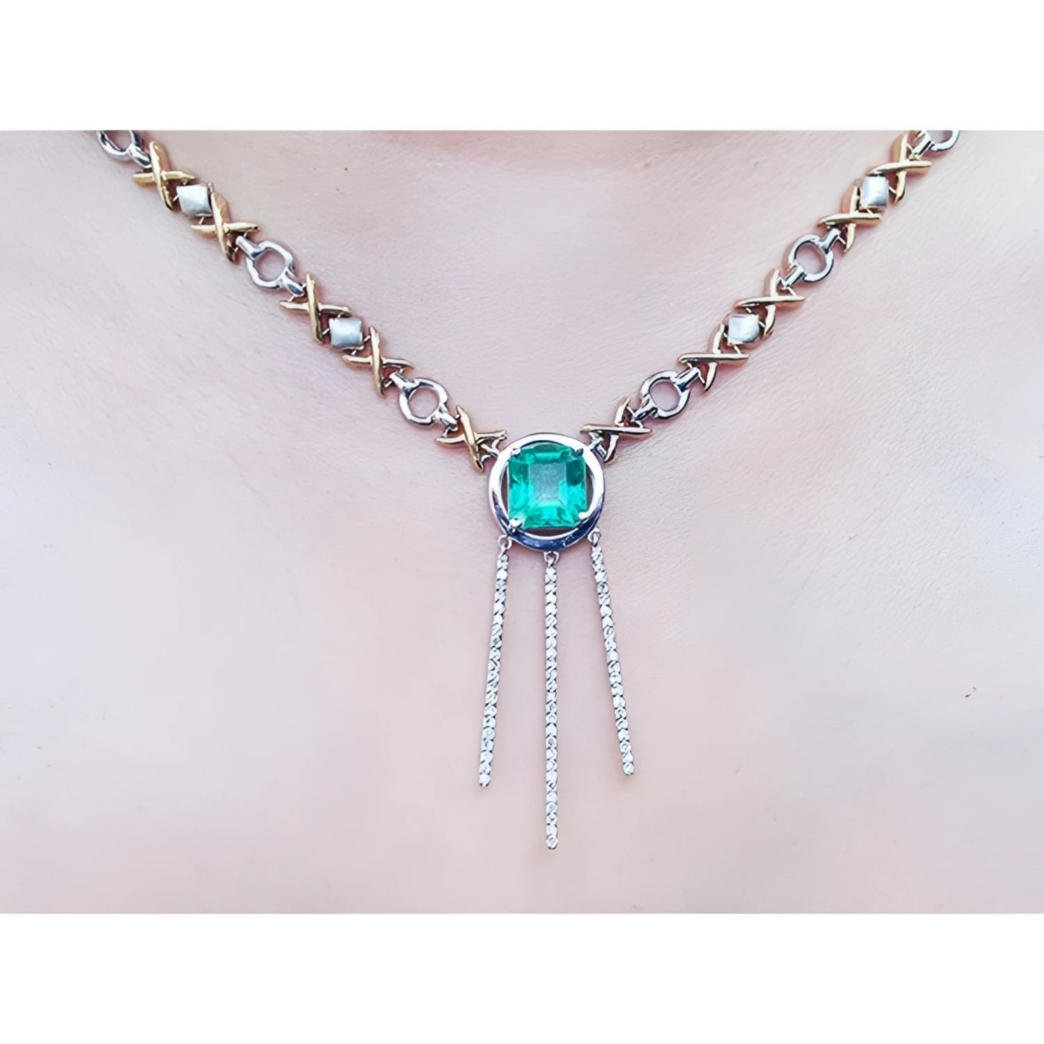 14K white and yellow gold Kisses and Hugs necklace with a square emerald pendant and diamond dangles.